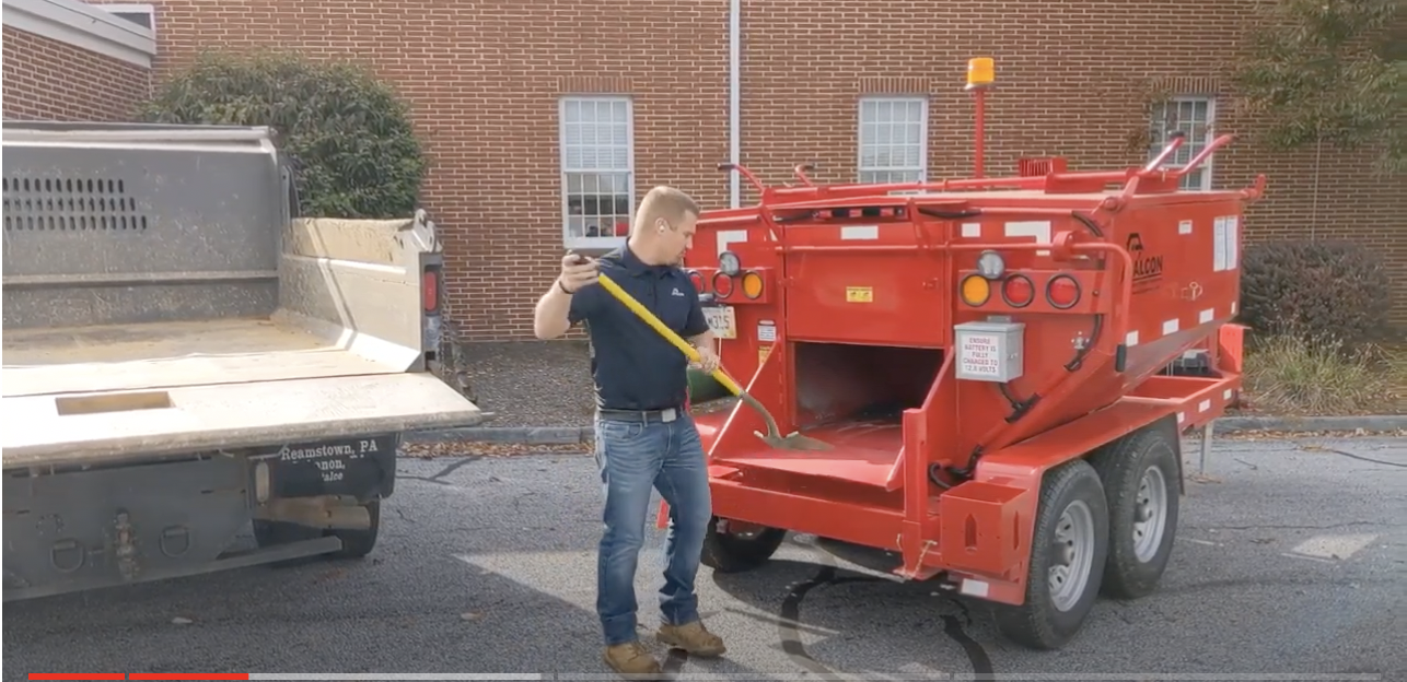 A demonstration of how much easier it is to use a Falcon HotBox to shovel asphalt.