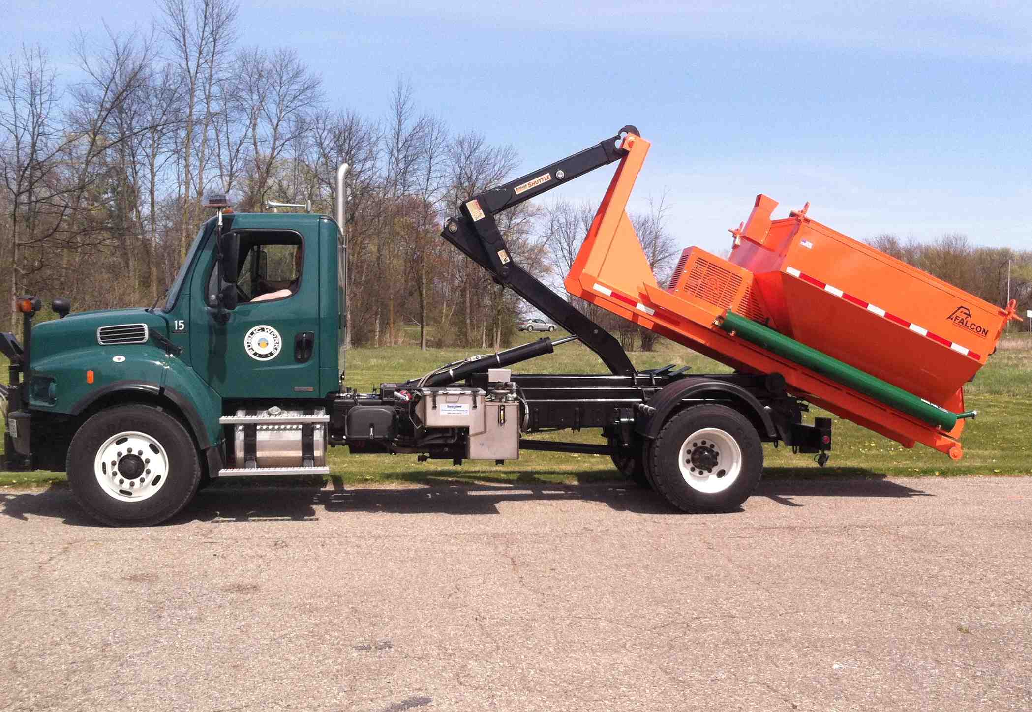 An orange, 6-ton, hook-lift, chassis-mount, asphalt hot box.
