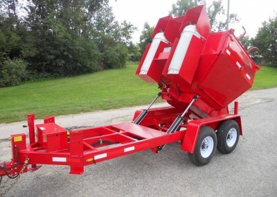 A red 2-ton Falcon asphalt recycling machine with dual burner system.